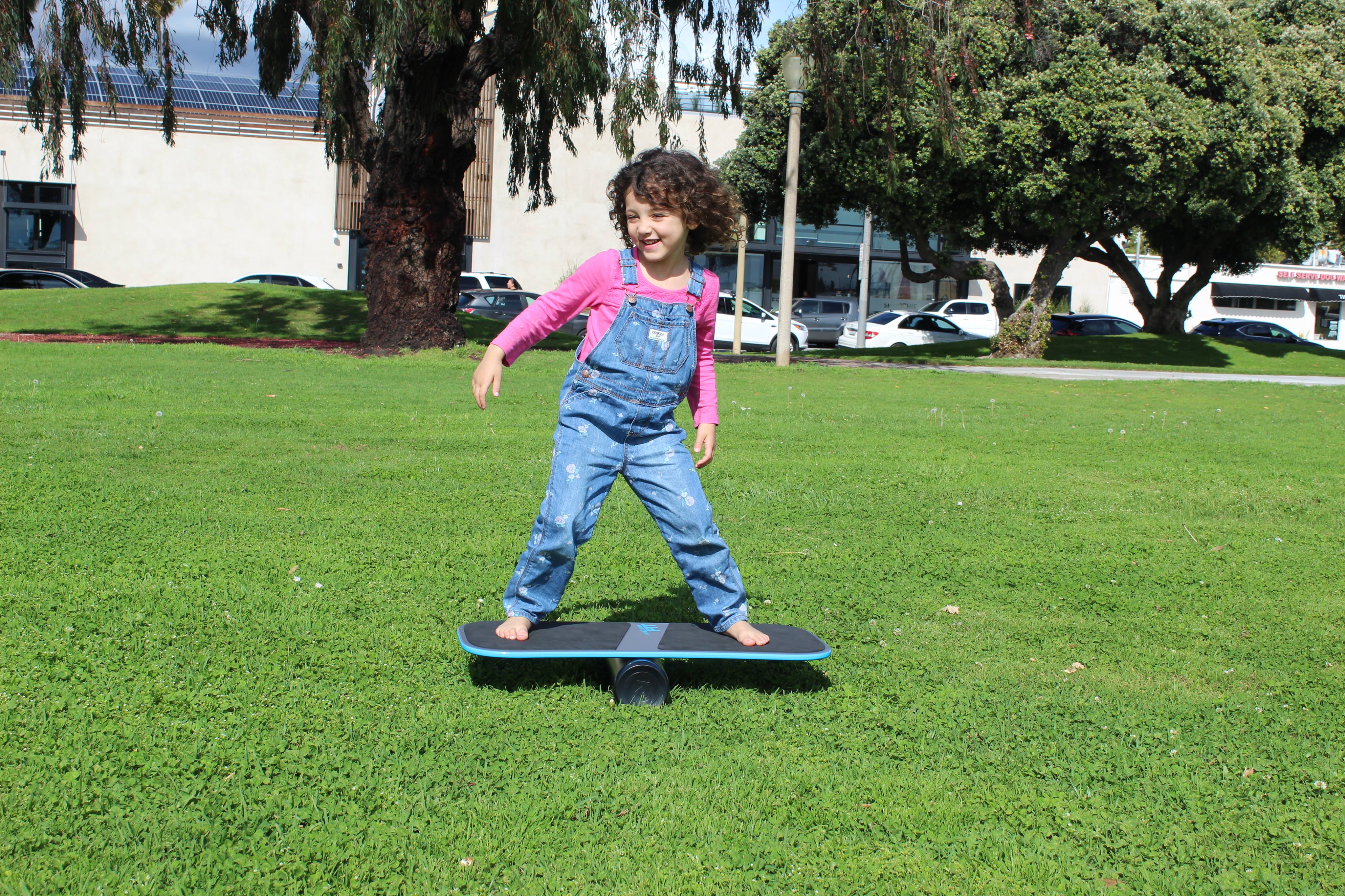 Katie, age 4, balancing on a Revolution Balance Board